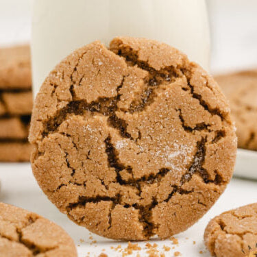 Ginger cookie with a crackly surface on a white background